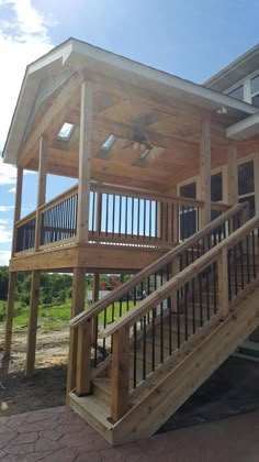 a wooden structure with stairs leading up to the top floor and second story above it