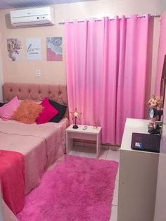 a bedroom with pink carpet and curtains on the windows