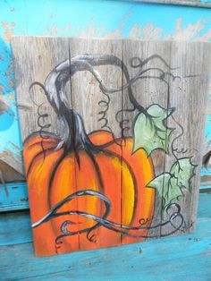 a painted wooden sign with a pumpkin on it