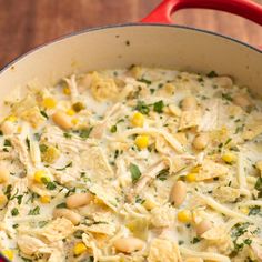 a casserole dish with white beans, chicken and corn is shown in a pan