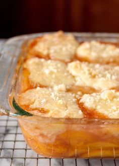 a casserole dish on a cooling rack with some bread crumbs in it