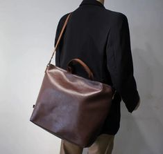 Material: PU Texture: Soft Closed: Zipper Size: 18.90"L x 5.51"W x 15.35"H in; It is enough to hold daily stuff including cell phones, sunglasses, wallet, key, etc. Baldric: Adjustable shoulder strap Brown Large Capacity Laptop Bag For On-the-go, Versatile Brown Travel Bag For Daily Use, Versatile Brown Laptop Bag With Large Capacity, Versatile Large Capacity Brown Laptop Bag, Handheld Briefcase With Large Capacity For Everyday Use, Everyday Large Capacity Handheld Travel Bag, Brown Duffle Bag With Zipper Pocket For Everyday, Brown Duffle Bag With Zipper Pocket, Everyday Crossbody Briefcase With Large Capacity