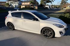 a white car is parked on the street