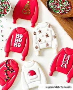 cookies decorated with sweaters and sprinkles on a table