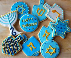 decorated cookies with the words happy hanukkah written in gold and blue frosting