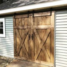 a garage with two wooden doors on it