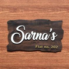 a wooden sign that says sara's flat no 20 on it, with the name sara