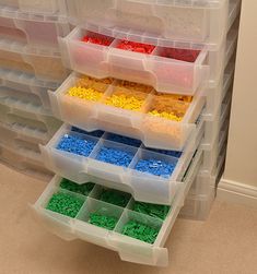 plastic storage bins filled with different colored legos