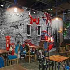 the interior of a restaurant with tables, chairs and an old - fashioned red double decker bus painted on the wall