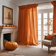 a living room with orange curtains and pumpkins on the fireplace mantel in front of it