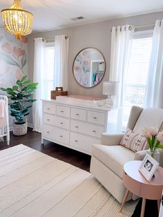 a baby's room is decorated in pink and white