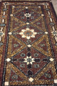 an intricately designed area rug on the floor