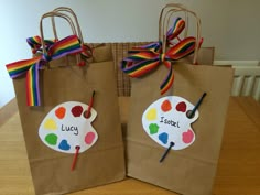 two brown paper bags decorated with colorful paintbrushes and the words lucky on them