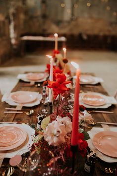 the table is set with candles and plates