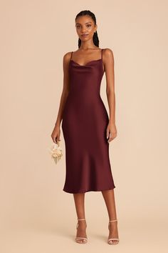 a woman wearing a burgundy slip dress