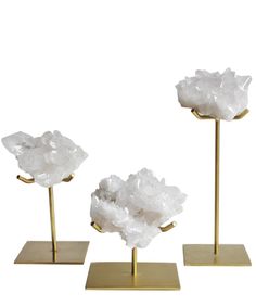 three pieces of white rock sitting on gold bases