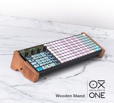 a calculator sitting on top of a white marble counter next to a wooden stand