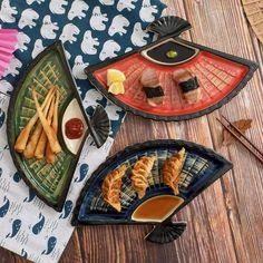 three plates filled with food on top of a wooden table