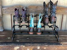 four pairs of boots are lined up on a bench