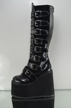 Swing   Black multiple buckle design  Metal tab shin guards on each strap Man Made sole 5.5" platform Full back zipper for easy on/off  women Sizes 6-12 ******Please note******These ship direct from Pleaser and size availability does varyRefund will be issued if your size or color is not availablecontact us with any qu Alt Shoes, Demonia Boots, Alternative Shoes, Demonia Shoes, Gothic Shoes, Shin Guards, Goth Punk, Knee Boot, Hot Shoes