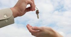 two people handing keys to each other in front of a sky background with the words ve started in 1989 when the average price of a new home was $ 28, 6000 00