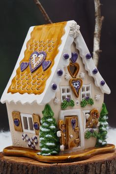 a gingerbread house on top of a tree stump