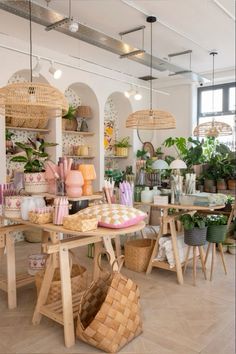 a room filled with lots of plants and wicker baskets