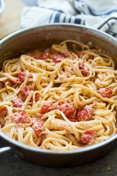 a pan filled with pasta and sauce on top of a table