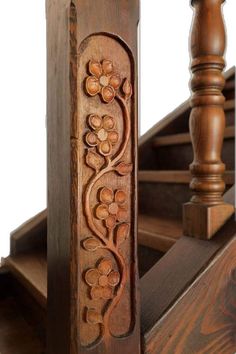 an intricately carved wooden stair rail with handrails