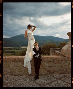 a woman in a white dress standing next to a man