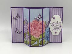 an open card with flowers and butterflies on it