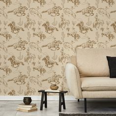 a living room with a couch, chair and wallpaper that has an animal design on it