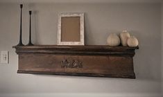 an old mantle with two vases on it