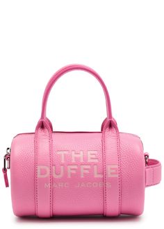 Find MARC JACOBS The Duffle Mini Leather Top Handle Bag on Editorialist. This Marc Jacobs grained leather top handle bag features two top handles, a detachable adjustable shoulder strap, a designer-stamped front, a logo print, a tab detail at the side, a designer plaque at the back, and a zip fastening across the top. The bag is a mini duffle style measuring 7.5 inches in width, 4.5 inches in height, and 4.5 inches in depth. The top handle drop is 4 inches, while the minimum and maximum shoulder strap drops are 22 inches and 26 inches respectively. Aesthetic Shoulder Bag, Contemporary Accessories, Everyday Bag, Handle Bag, Pink Bag, Leather Top, Travel Luggage, Luggage Bags, Logo Print