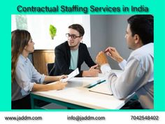 three people sitting at a table talking to each other with the words contact staffing services in india