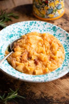 a bowl filled with macaroni and cheese on top of a blue and white plate