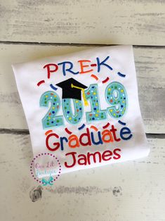 Is your little one ready for their graduation? This listing is for one shirt or bodysuit, with the Grad appliqué shown above. The wording can be changed for other grades. 2019 Graduation. Embroidered on white cotton bodysuit or t-shirt. If you have other color options in mind feel free to convo us to discuss! If you like the style of this birthday shirt we can do other designs similar. Please message me and we can discuss what you would like! When will this ship? How do the sizes run? Check the Crew Neck Tops For Graduation, School Spirit Tops For Graduation Gift, Graduation School Spirit Short Sleeve Tops, School Spirit Tops For College Graduation, Cotton Short Sleeve Tops For Graduation Party, School Spirit Short Sleeve Tops For Graduation Party, School Spirit Tops For Graduation Party, Cotton Tops For Graduation, White Cotton Top For Graduation Party