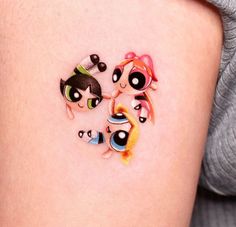 two cartoon characters on the side of a woman's thigh