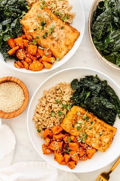 two white plates filled with different types of food on top of a marble countertop