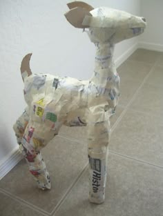 a dog made out of newspaper paper on the floor