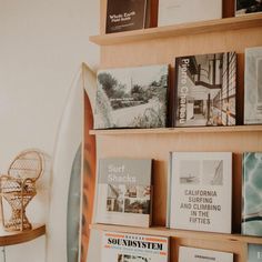 there are many books on the shelves in this room and one surfboard is next to it