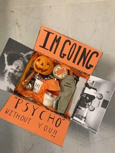 an orange box filled with halloween items on top of a tiled floor