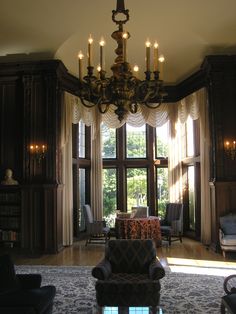 a living room filled with furniture and a chandelier