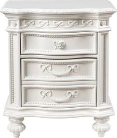 an ornate white dresser with drawers