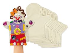 a hand holding a bunch of white gloves with a clown face on it's back