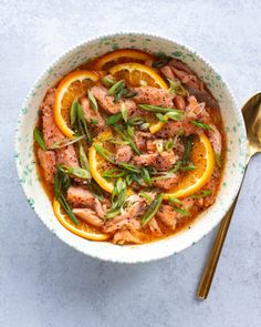 a bowl filled with meat and orange slices