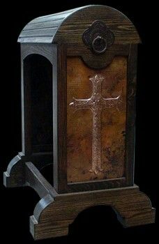 an old fashioned wooden clock with a cross on it's front and side panels