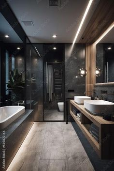 a modern bathroom with two sinks and a large mirror above the bathtub is lit by recessed lights