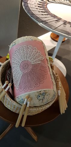 a cake that is sitting on top of a table with some knitting needles in front of it