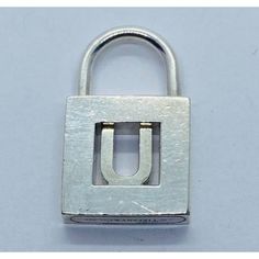 an open metal padlock with the letter u in it's center and bottom section